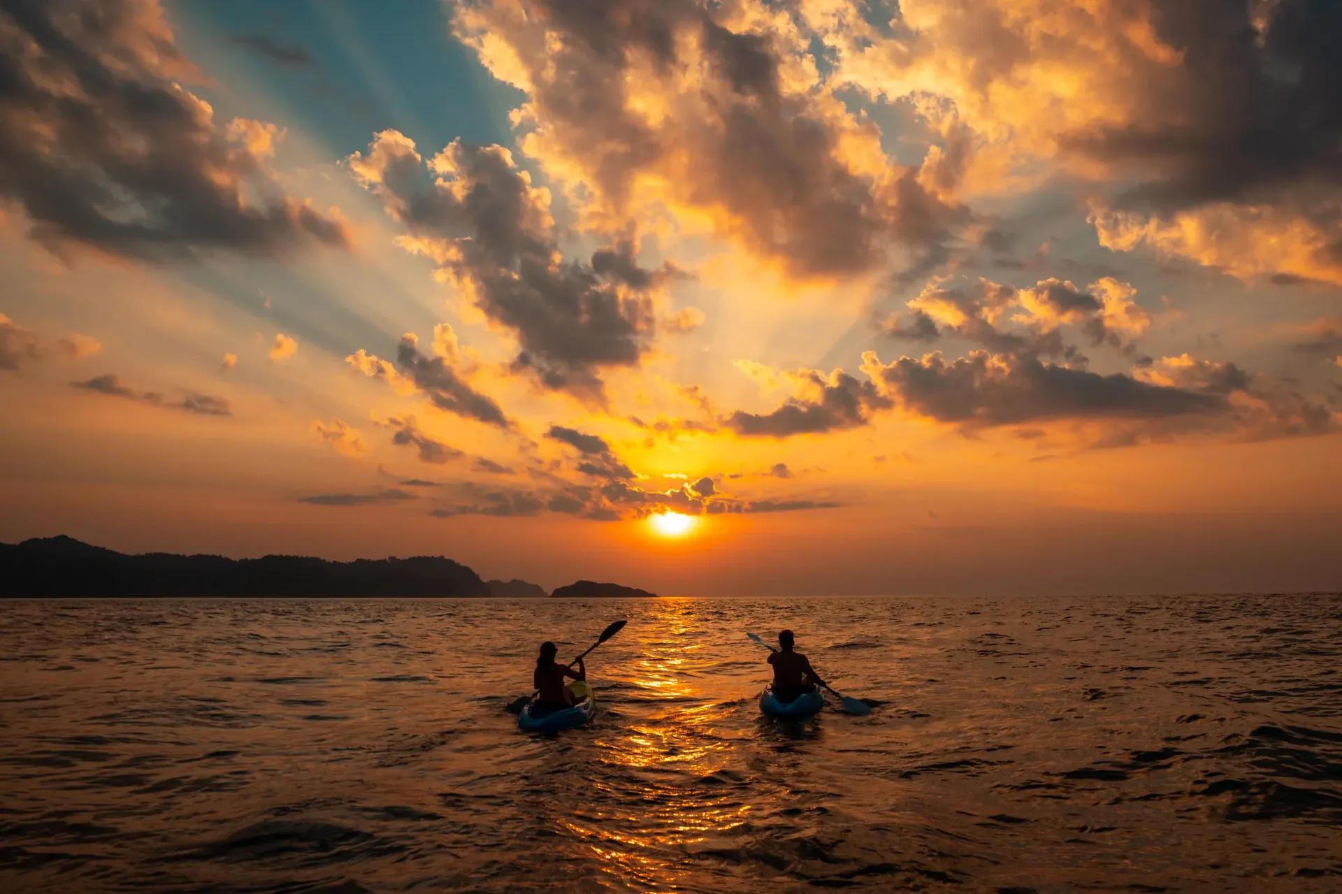 Asia Global Yachting (AGY) Female And A Male Sailing With Canoes Close To Each Other At Sunset